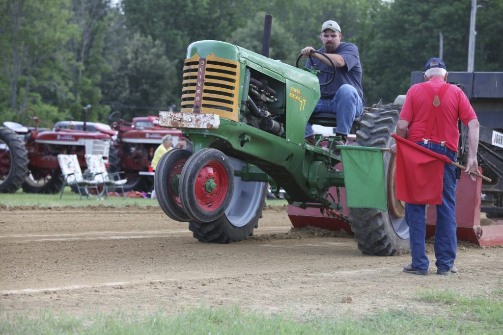 Edinburgh, Indiana; USA aa June 14, 2013: An unknown man operates an antique Oliver 77 Row-Crop tractor in an antique tractor pull, at the 22nd Annual Johnson County Antique Machinery Association Show.