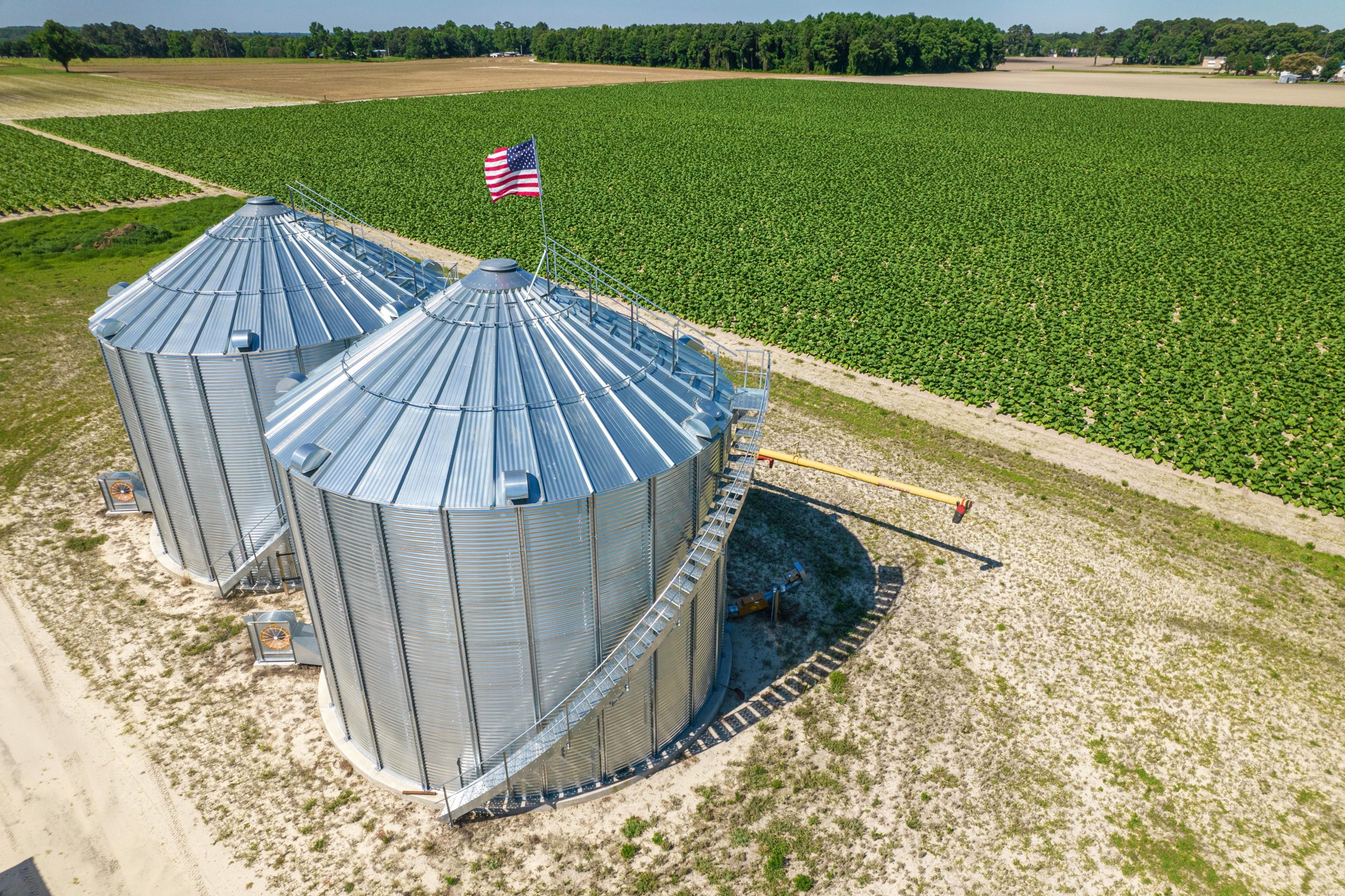 Aerial footage of grain bins near cropland