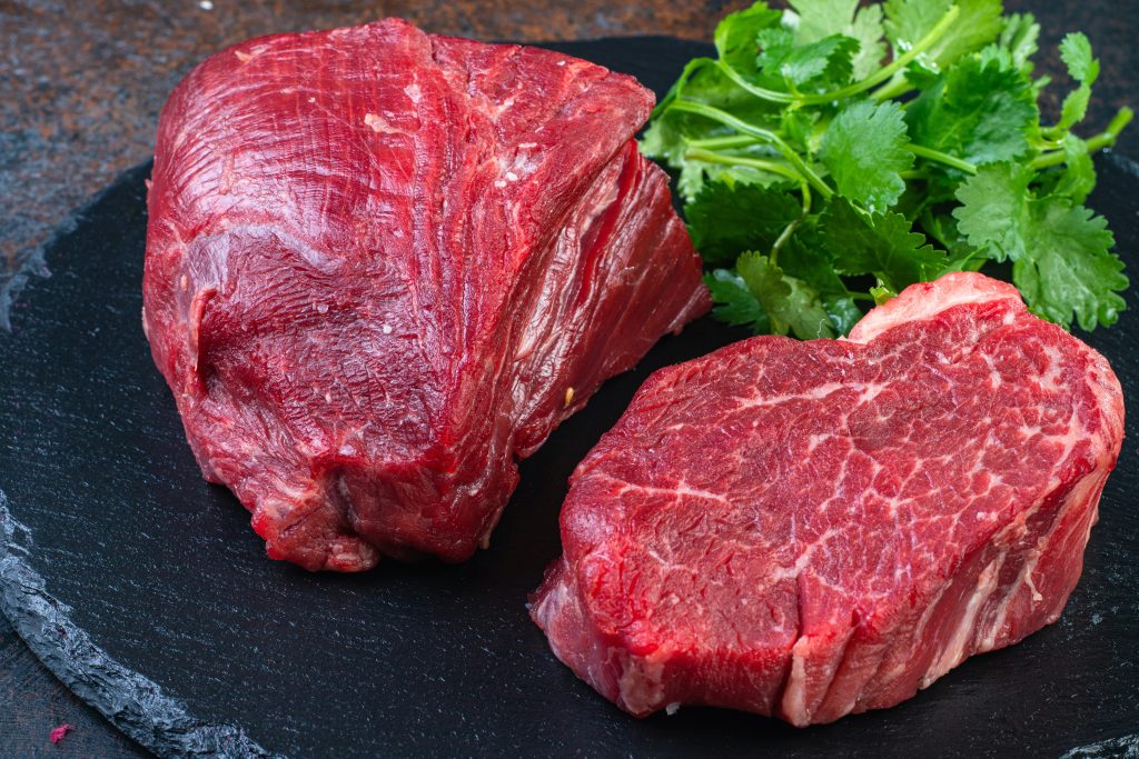 Two steaks on a plate with parsley