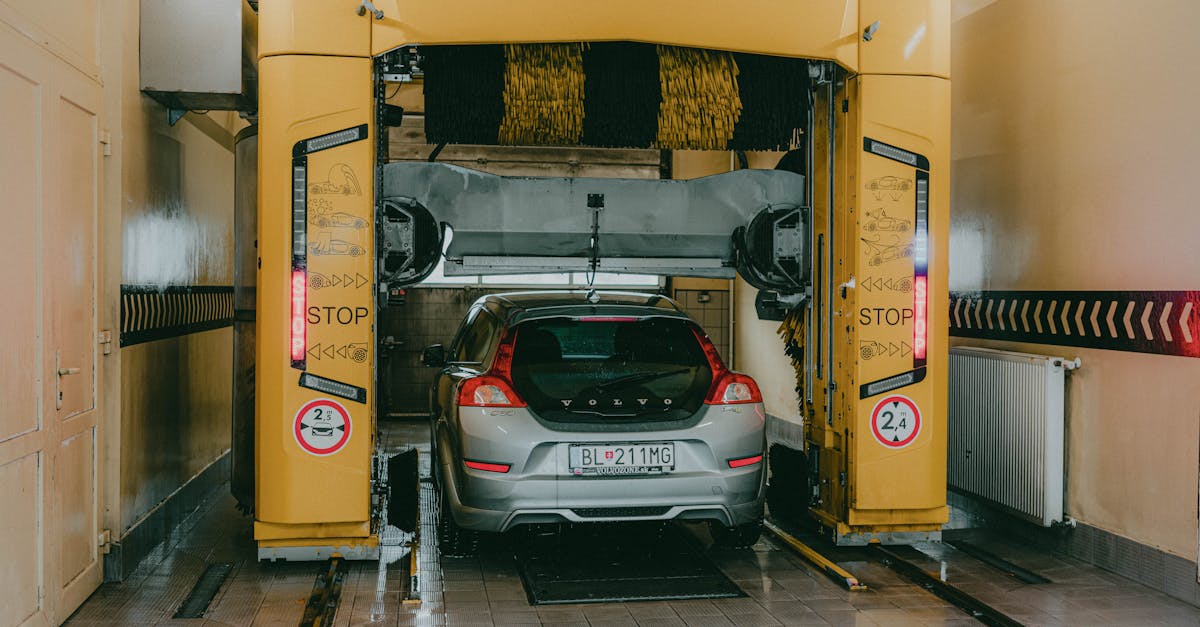 a car undergoing a wash in a modern automated car wash station indoors