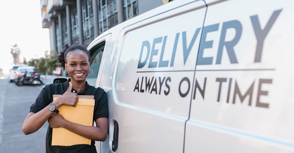 a cheerful delivery woman standing by a van with a parcel ready for delivery 1