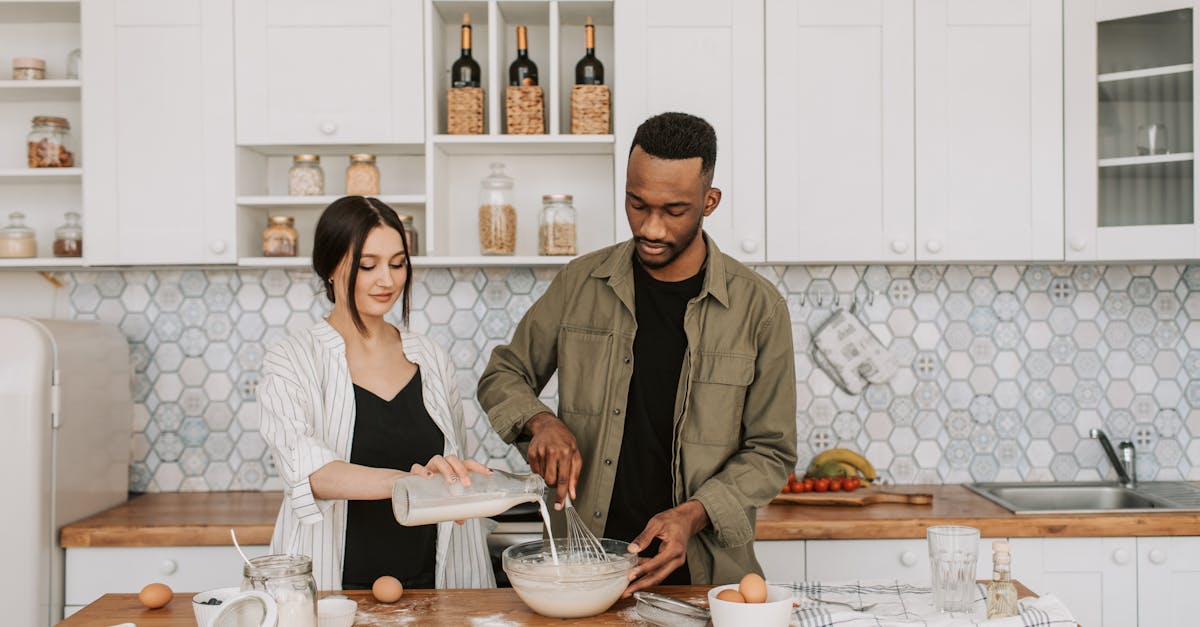 a couple collaboratively prepares a meal in a stylish contemporary kitchen setting