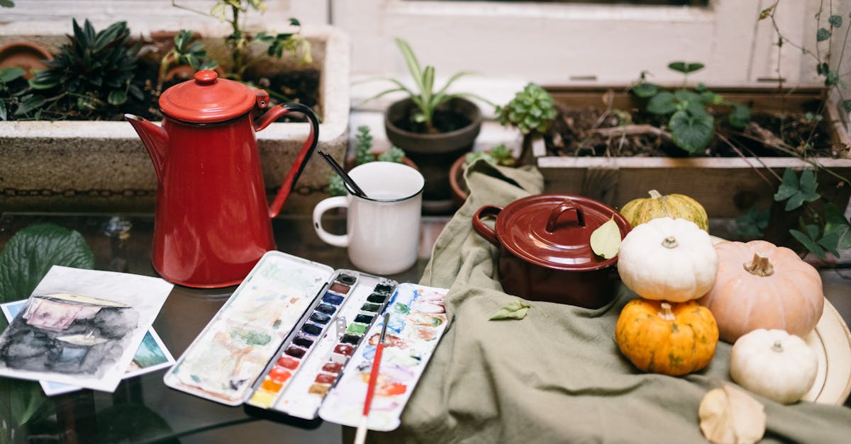 a cozy indoor scene with art supplies pumpkins and a teapot on a table perfect for creative autum