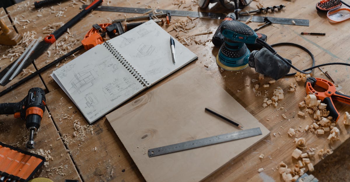 a detailed view of woodworking tools and sketches on a workshop table showcasing the craft of carpe