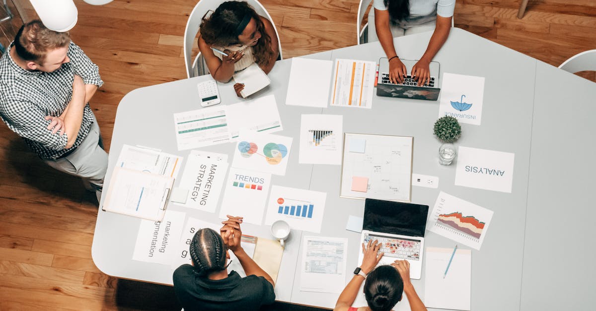 a diverse group working on marketing strategies with charts and laptops in an office setting