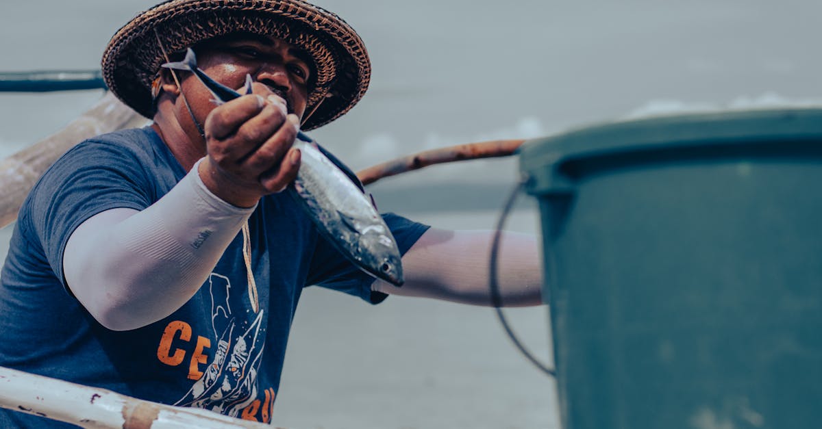 a fisherman in ginatilan philippines holds a fresh fish showcasing traditional livelihood