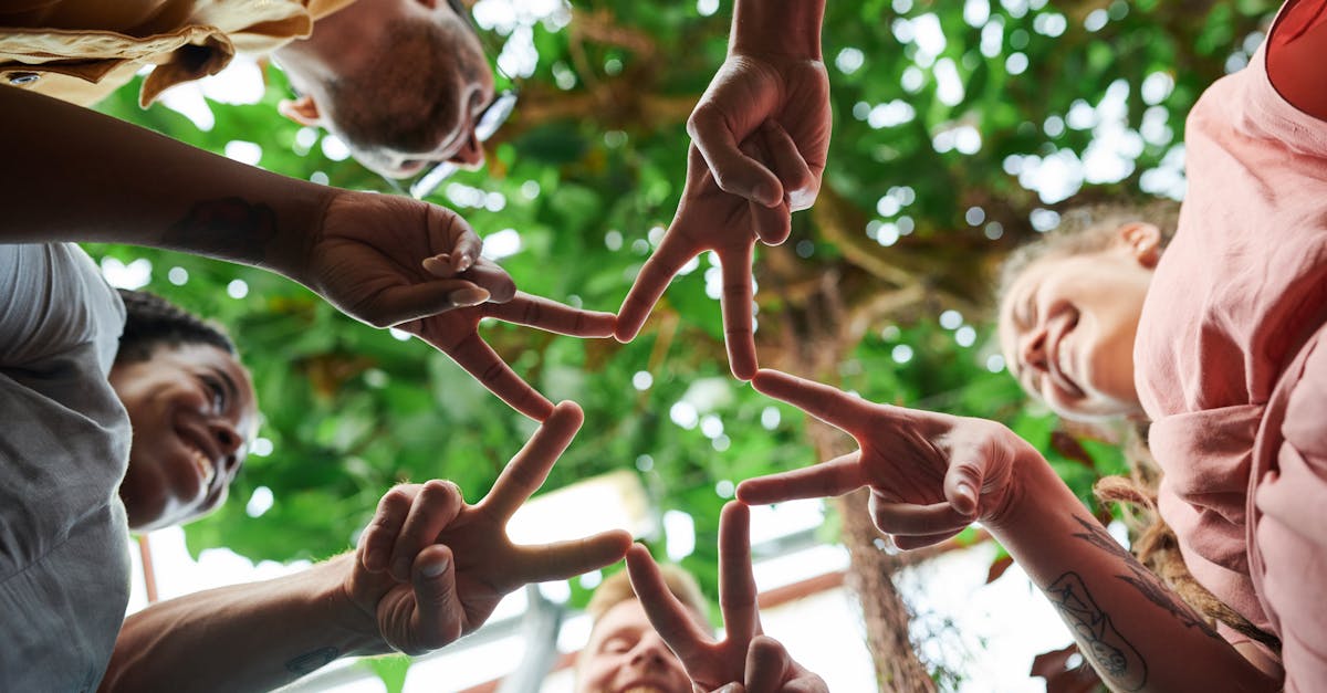 a group of friends creating a star shape with their fingers symbolizing unity and friendship