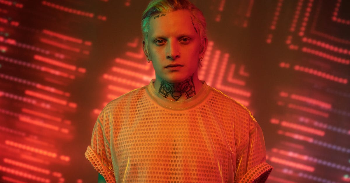 a striking portrait of a person with tattoos illuminated by dynamic neon lights