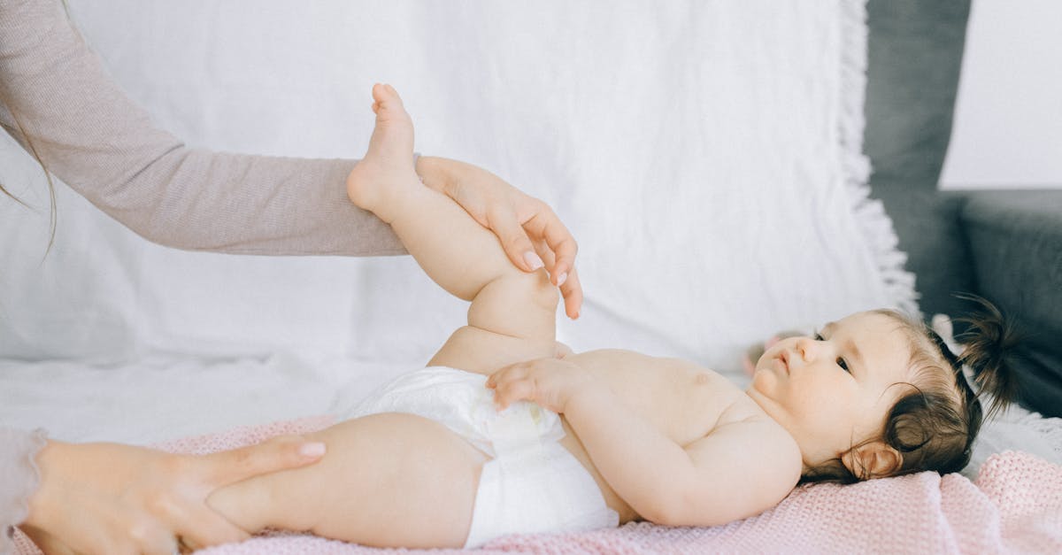 a tender moment with a baby receiving a gentle massage on a bed