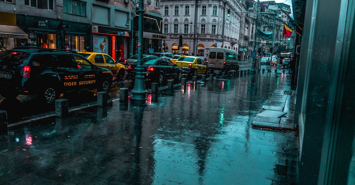 a wet city street with traffic and classic architecture reflecting calm ambiance on a rainy day