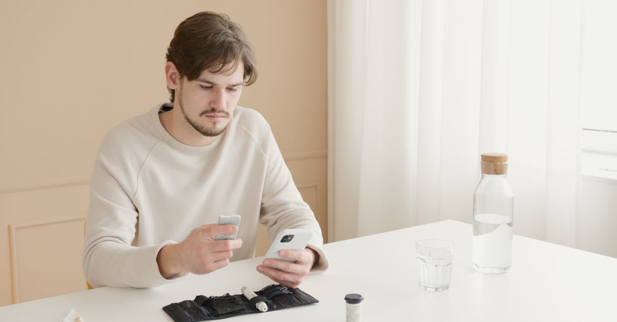 a young man checks his blood glucose level using a glucometer at home