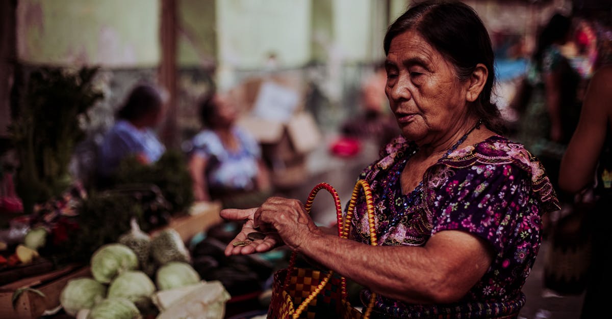 an elderly woman with a woven basket shops for vegetables at a lively outdoor market