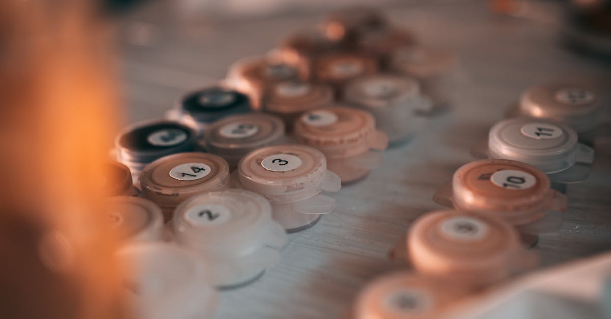 artistic close up of numbered paint pots on a table ideal for painting by numbers enthusiasts