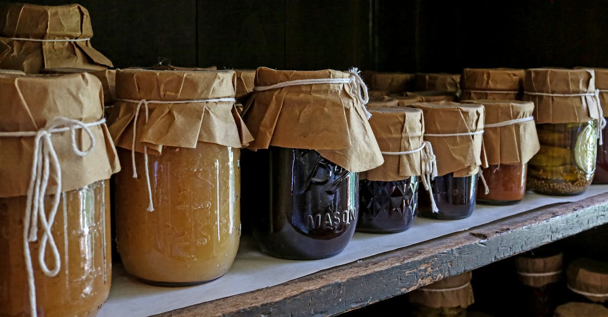 assorted preserved foods in glass jars on a wooden shelf showcasing traditional storage methods