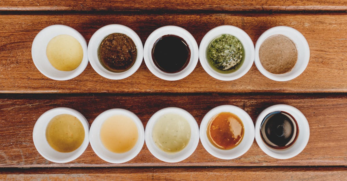 assorted sauces displayed in bowls on a rustic wooden table