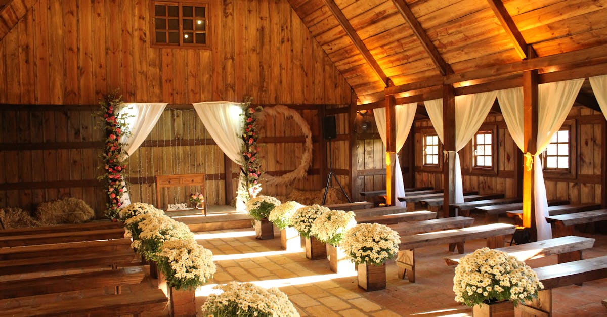 charming wooden barn decorated for a wedding with floral arrangements and soft lighting