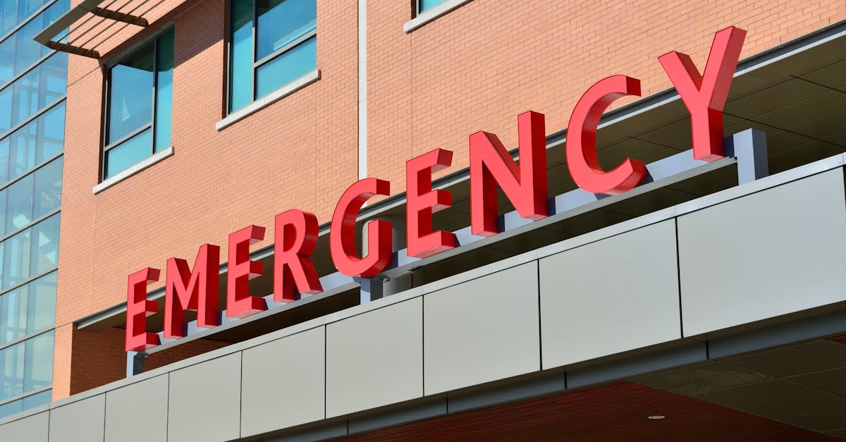 close up of a modern hospital emergency room entrance with prominent red letters