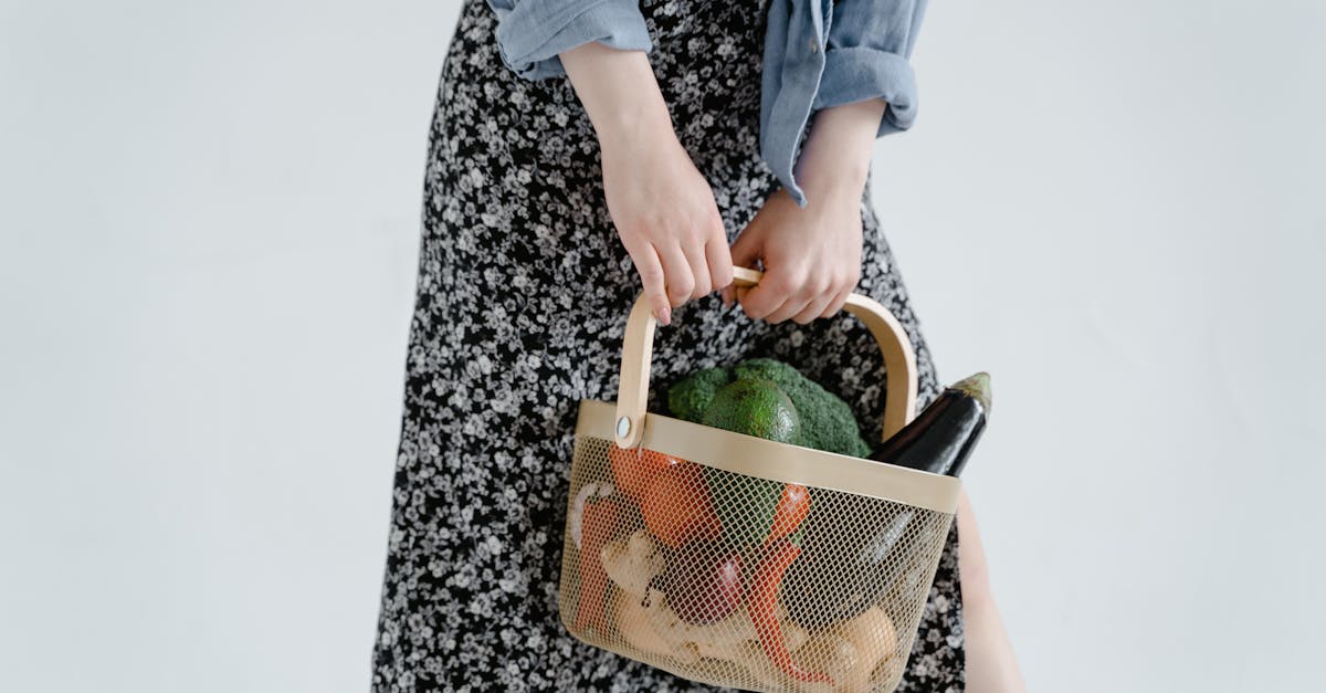 close up of a woman holding a basket filled with fresh vegetables emphasizing healthy and organic l