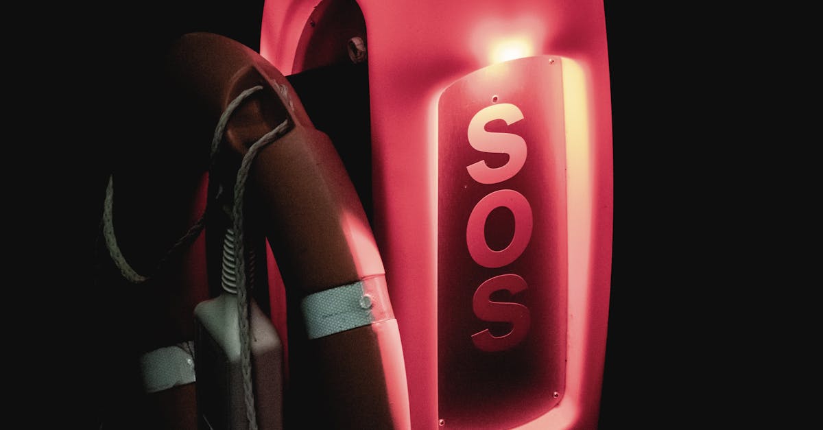 close up of an illuminated sos lifebuoy for emergency rescue at night