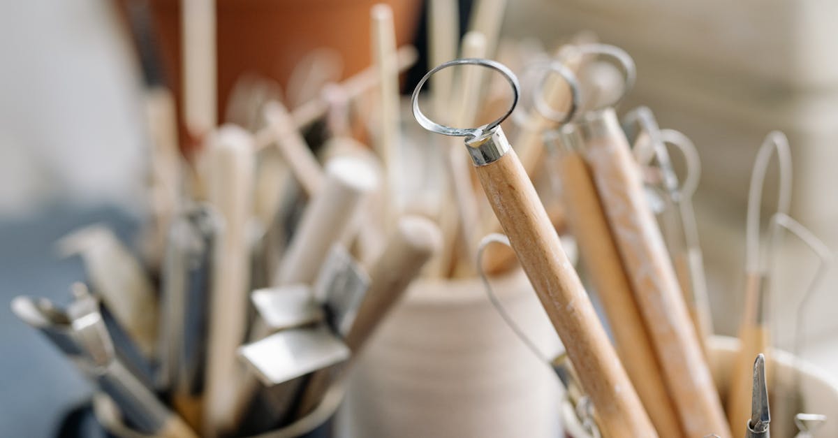 close up of pottery tools in cups for crafting and sculpting perfect for art projects