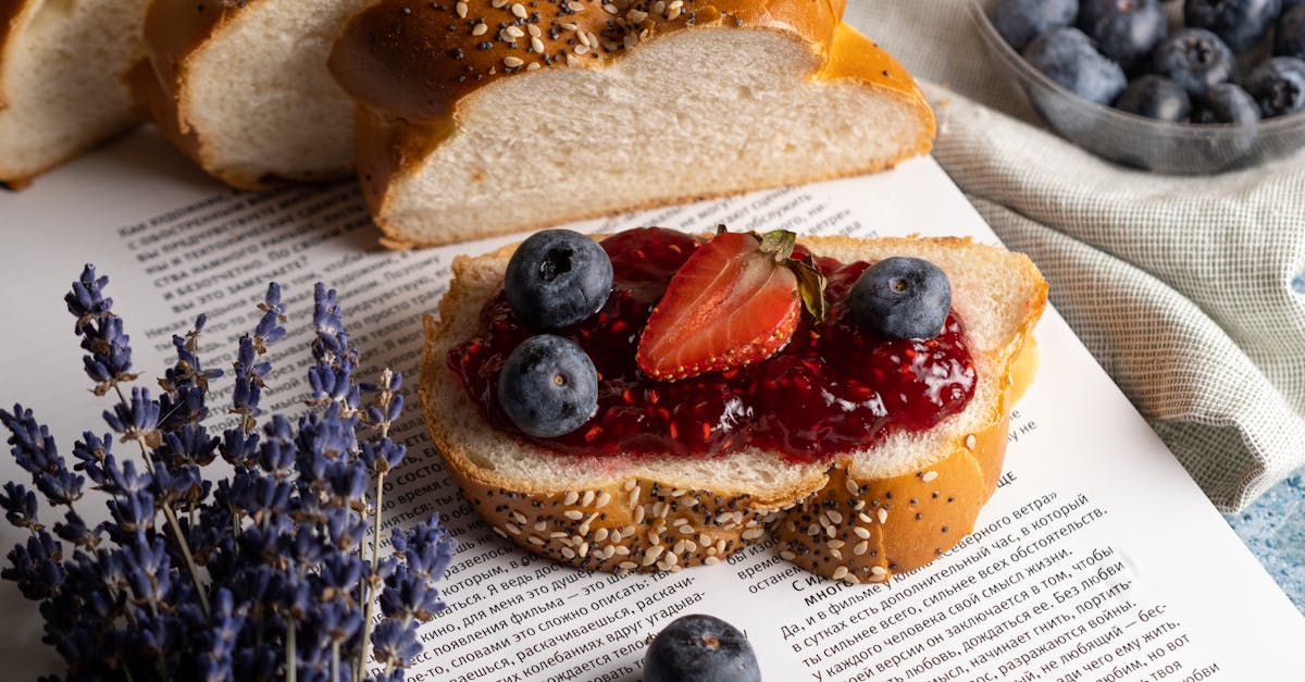 close up of seeded bread with berry jam fresh blueberries and strawberries