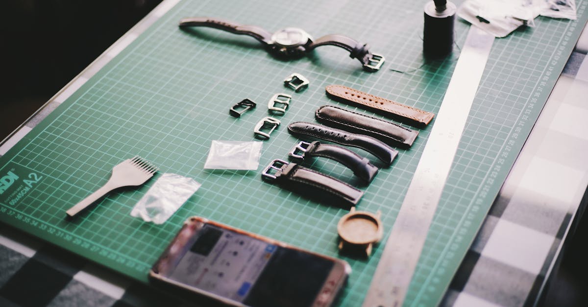 close up of watchmaking tools and leather straps on a crafting table