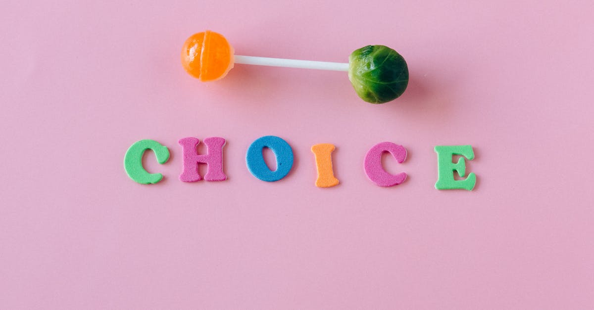 colorful choice between candy and vegetable on pink background