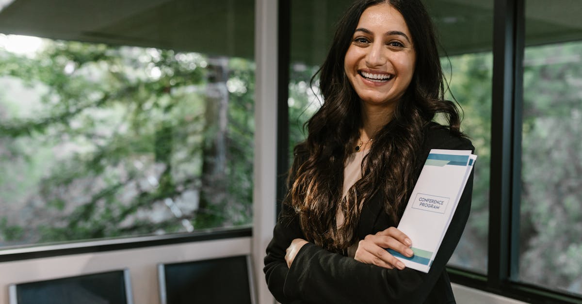 confident woman holding conference program smiling in modern indoor setting