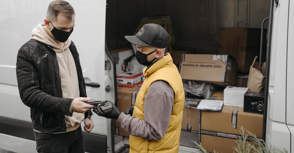 courier handing over package to customer for contactless delivery by a van