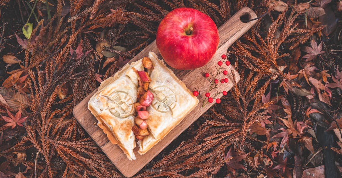 delicious autumn themed apple pastry on a wooden board surrounded by fall leaves