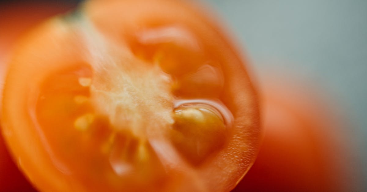 detailed close up of a ripe cherry tomato showcasing its juicy texture and vibrant color 1