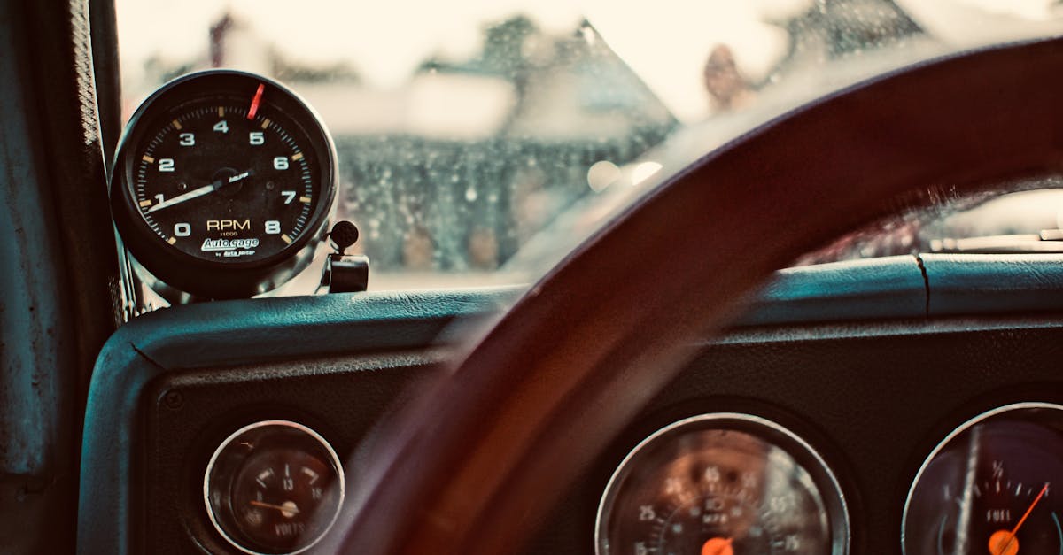 detailed view of a vintage car dashboard featuring rpm gauge speedometer and steering wheel