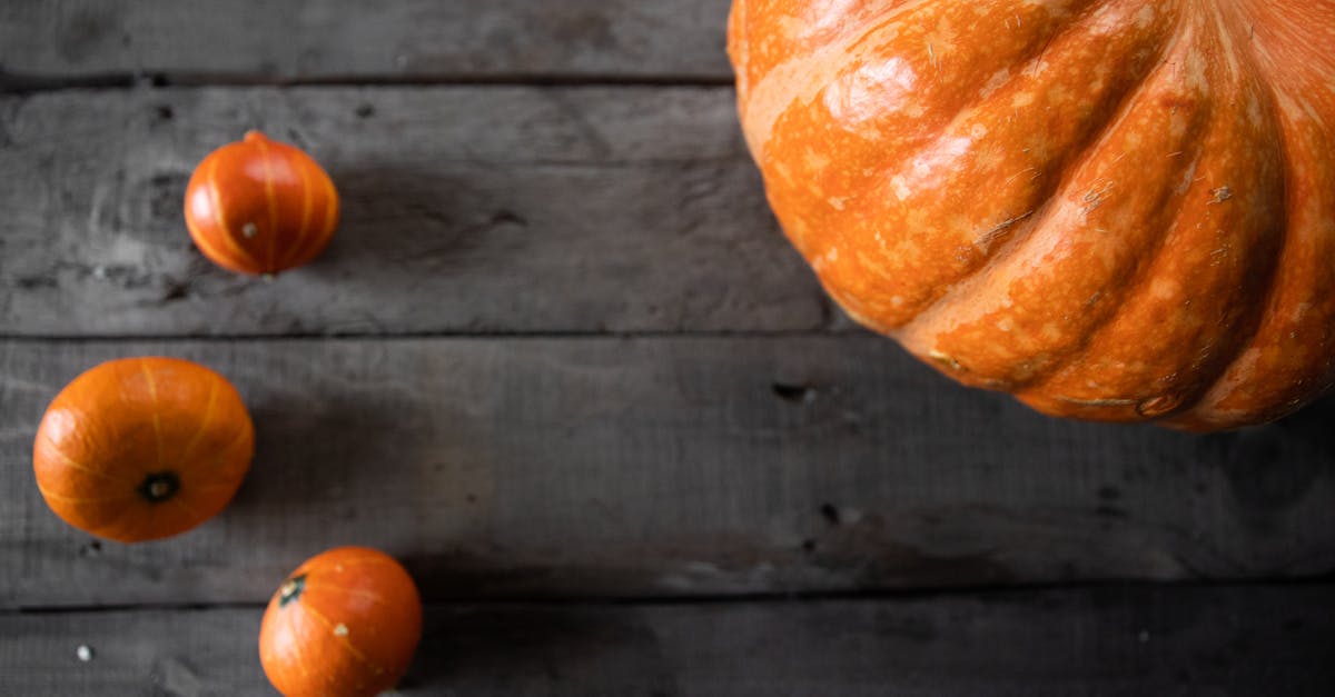 flat lay of orange pumpkins on a rustic wooden table perfect for halloween and fall themes