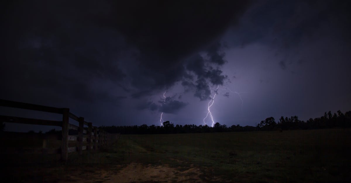 intense lightning illuminates a dark field capturing the power of nature during a nighttime thunder 1