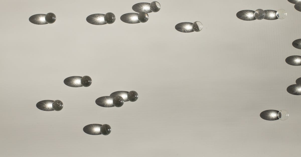 minimalist photo of glass spheres casting shadows on a light surface creating a unique abstract patt