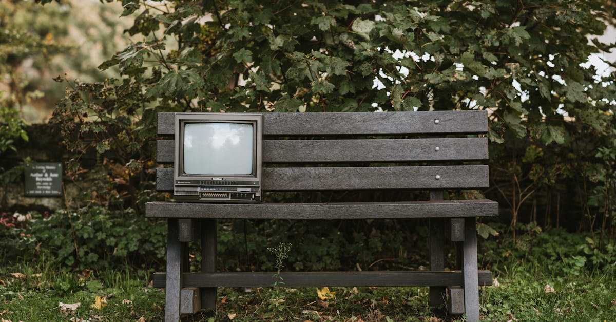 retro television set on an outdoor bench surrounded by lush greenery evoking nostalgia