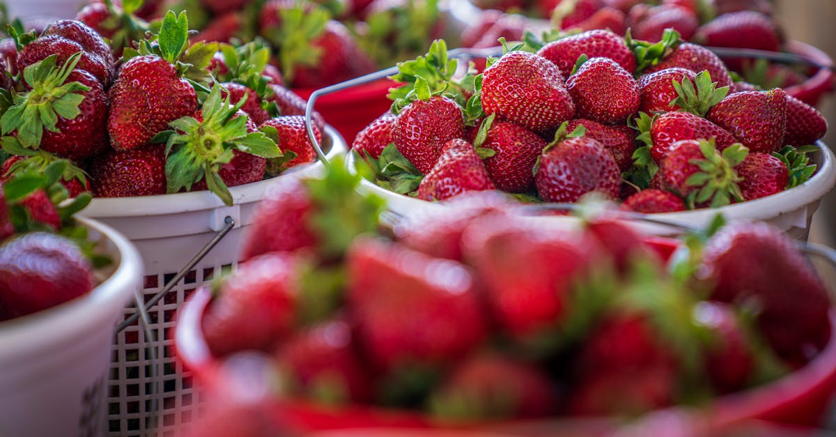 ripe red strawberries overflowing in baskets at a vibrant outdoor market