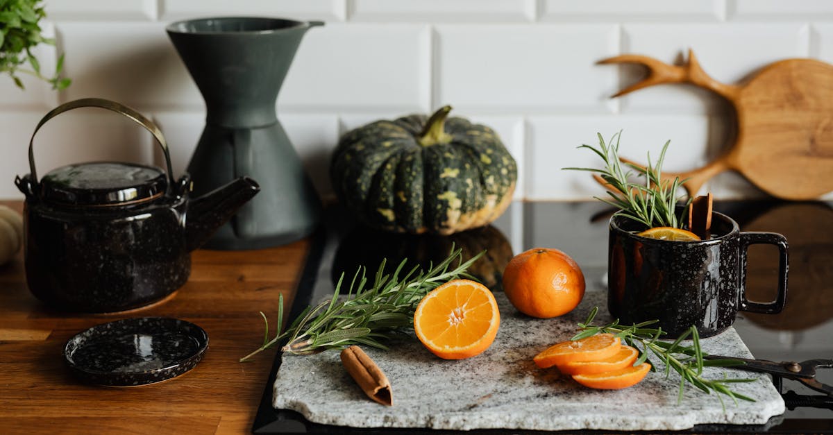 rustic kitchen scene with sliced orange herbs and a cozy drink perfect for autumn vibes