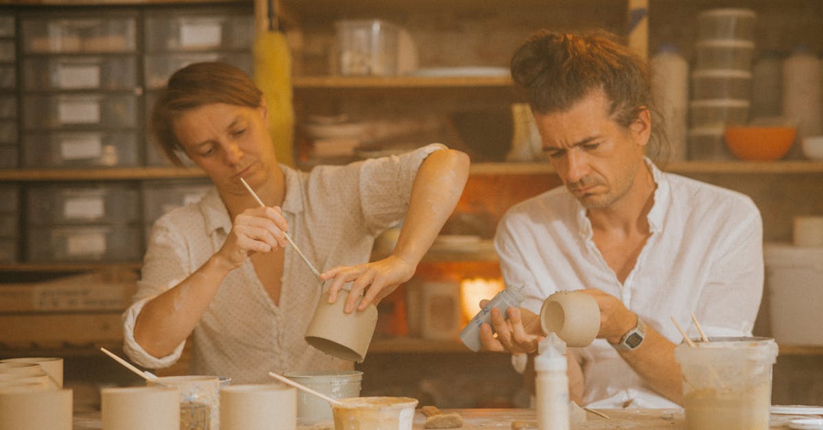 two adults crafting ceramics in a creative studio workspace