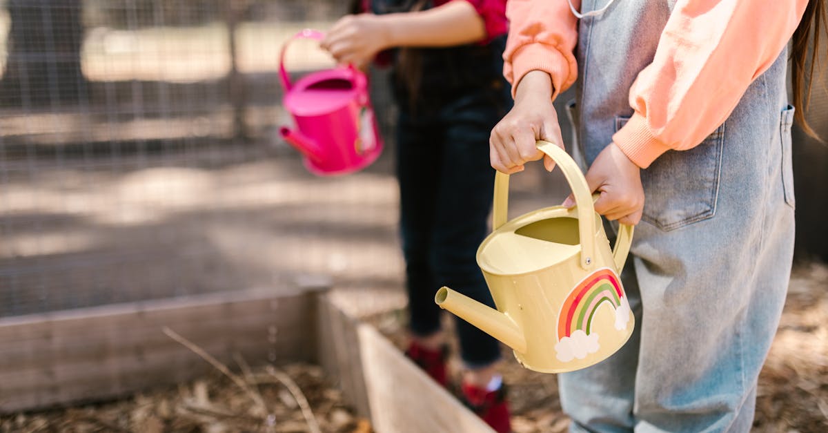 two children gardening outdoors with colorful watering cans promoting sustainability