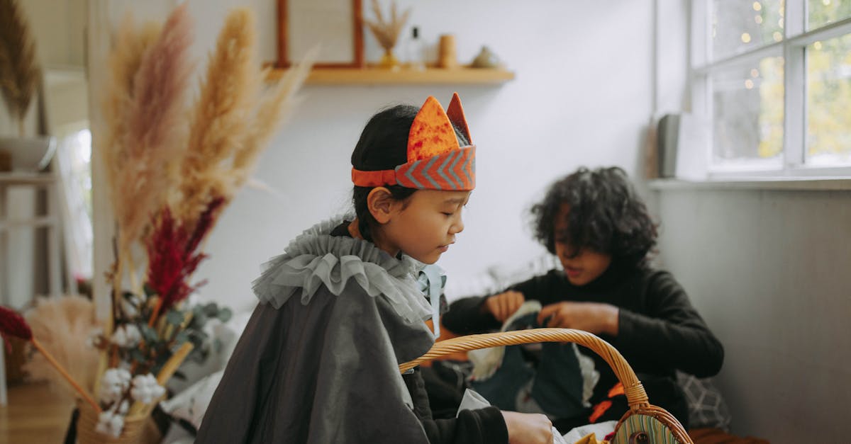 two children in creative halloween costumes enjoy indoor activities surrounded by festive decor