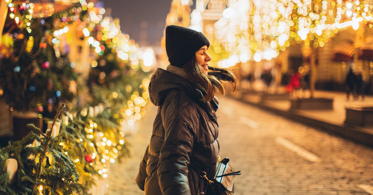 woman joyfully embraces the festive christmas lights on a wintry night