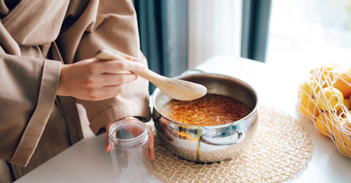 woman preparing citrus jam in the kitchen with fresh ingredients