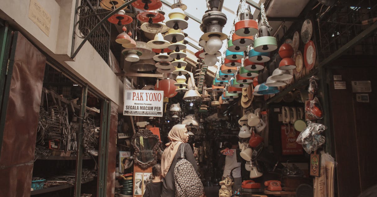 woman shopping in a vibrant indoor market filled with various items and hanging lamps