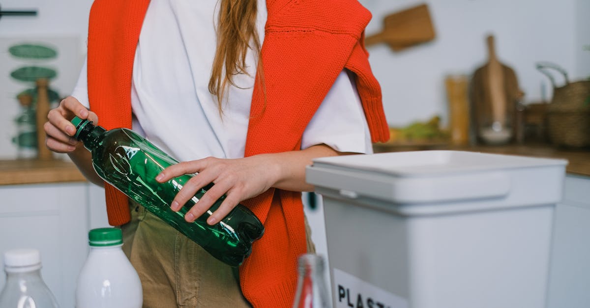 woman sorting plastic bottles into a recycling bin promoting eco friendly practices at home