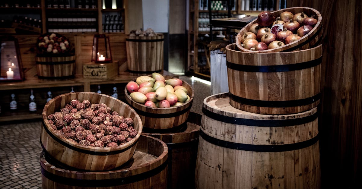 wooden barrels filled with various fruits in a rustic indoor setting